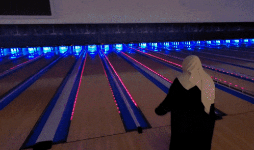 a bowling alley with blue and red lights