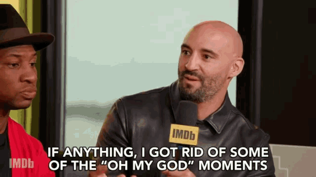 a man is talking into a microphone with the words " if anything i got rid of some of the oh my god moments "