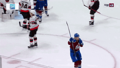 a hockey player in a blue jersey with the number 23 on it