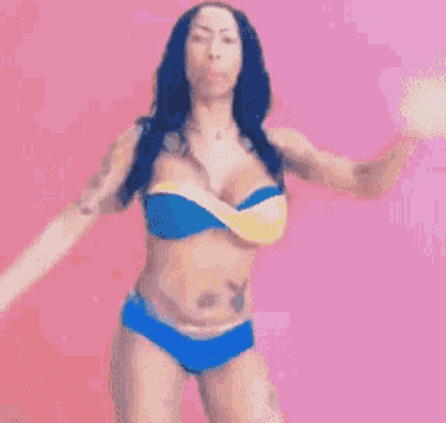 a pixelated image of a woman in a bikini standing on stairs