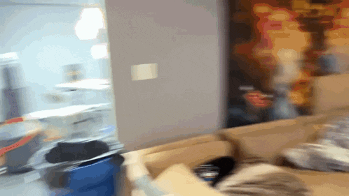 a blurry picture of a person sitting on a couch with a sign that says ' a ' on it