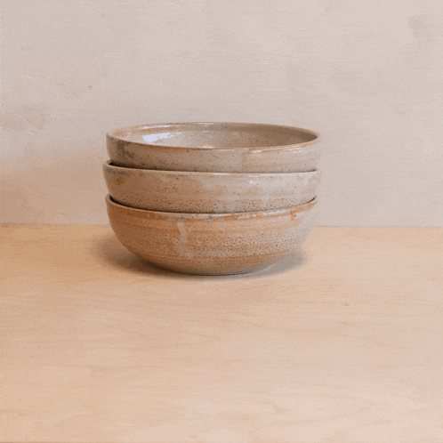 three bowls stacked on top of each other on a table