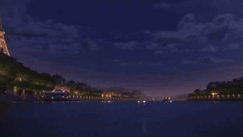 a hand giving a thumbs up in front of a body of water at night