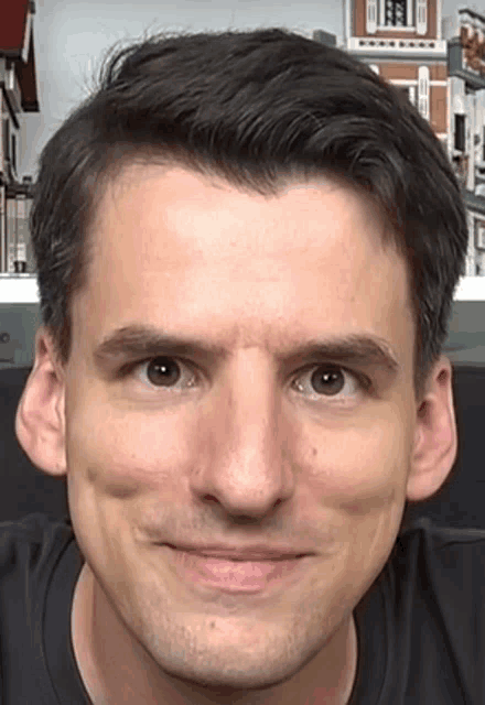 a close up of a man 's face with a slight smile on his face .