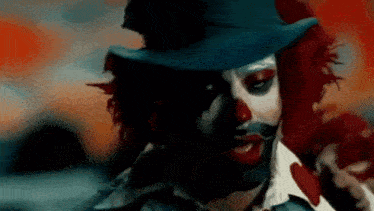 a close up of a clown wearing a top hat