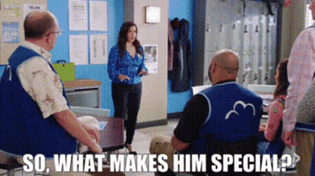 a group of people are sitting around a table and a woman is standing in the middle of the room talking to a man .