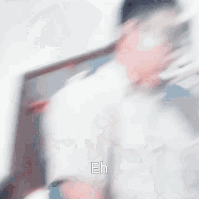 a blurry picture of a person with the word eh written on the bottom