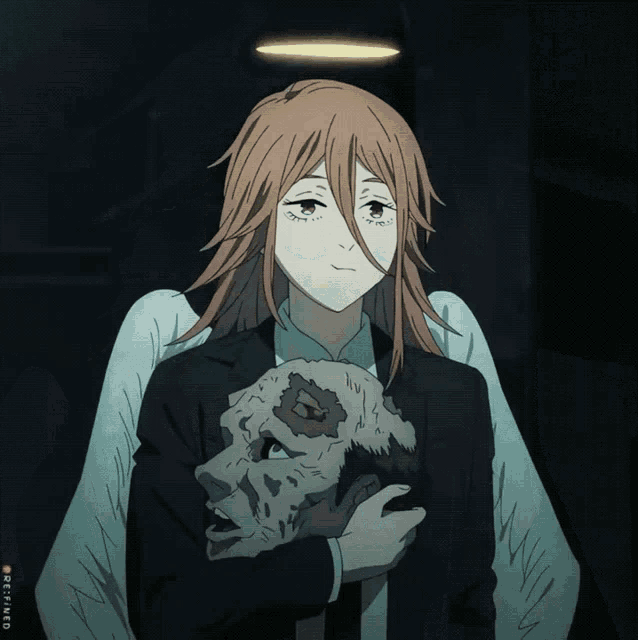 a girl with angel wings is holding a skull in her arms