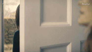 a woman is standing in a doorway with the word paradise on the bottom