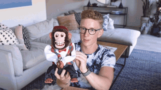 a man holds a stuffed monkey in his hands