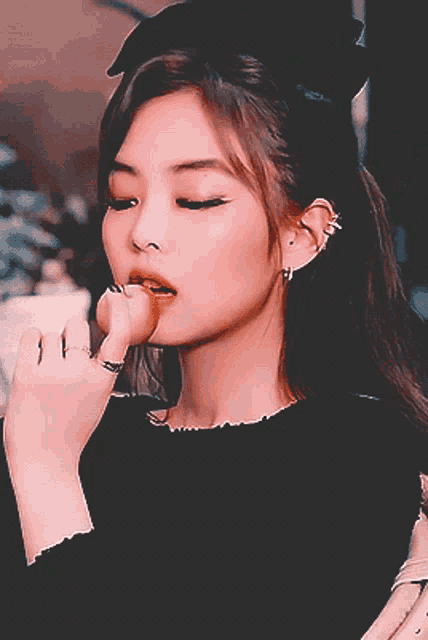 a close up of a woman eating a donut