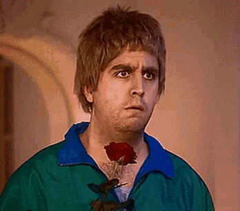 a man with a red rose in his mouth