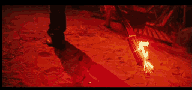 a person is holding a torch in their hand in the dark