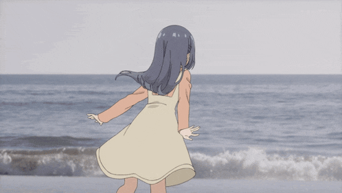 a girl in a white dress stands on a beach with her arms outstretched