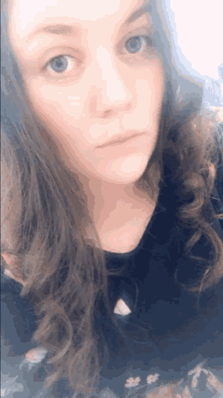 a close up of a woman 's face with long hair