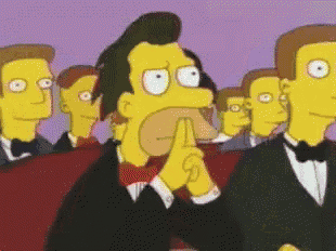 a group of men in tuxedos and bow ties are watching a cartoon