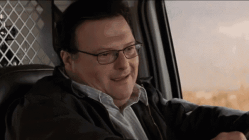 a man wearing glasses is sitting in a car
