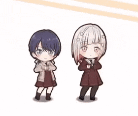 two little girls are holding hands and dancing together .
