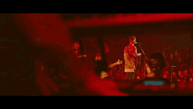 a close up of a person playing a keyboard with red lights