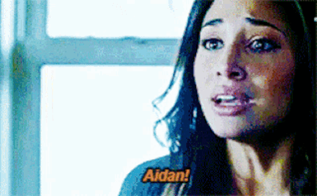 a close up of a woman 's face with the words " aidan " written on it