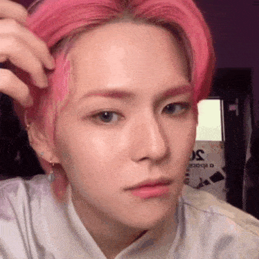 a close up of a person with pink hair .