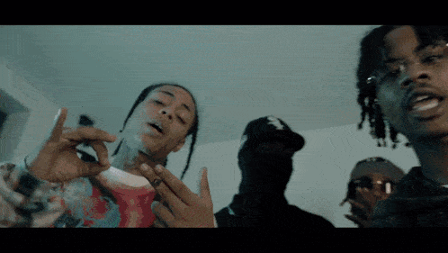 a man with dreadlocks is smoking a cigarette