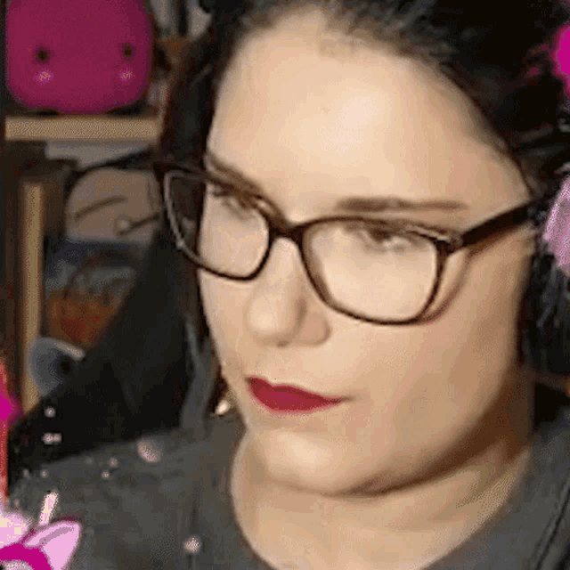 a close up of a woman wearing glasses and headphones