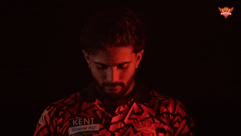a man wearing a red shirt that says ken