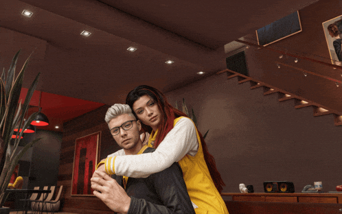 a man and a woman hugging in a living room with stairs in the background