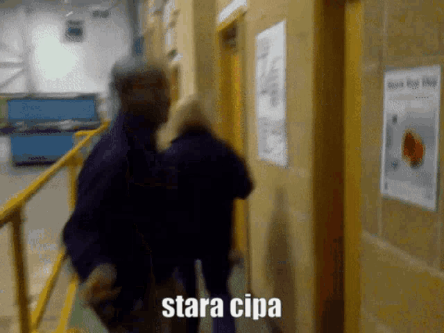 a blurred image of a man carrying another man with the caption " stara cipa " on the bottom