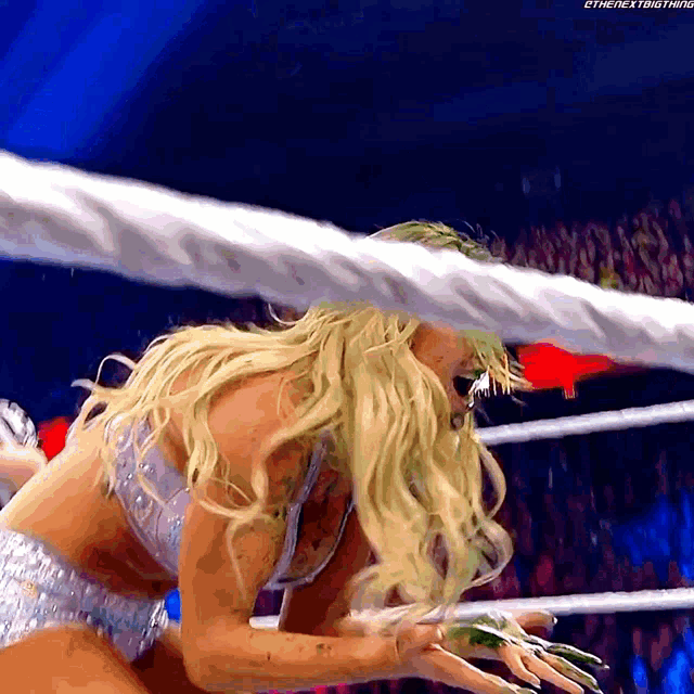 a woman in a wrestling ring with the words " the next thing " on the bottom