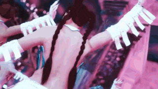 a woman in a costume is dancing with her arms outstretched in front of a crowd of people .