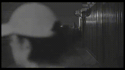 a black and white image of a camera lens with a pair of googly eyes in the foreground