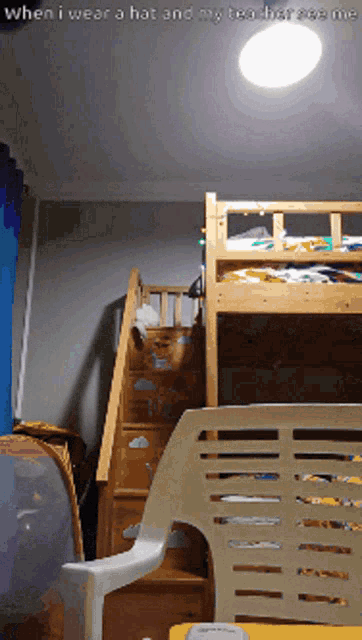 a room with a bunk bed and a chair with the words " when i wear a hat and my tea horse see me " at the top