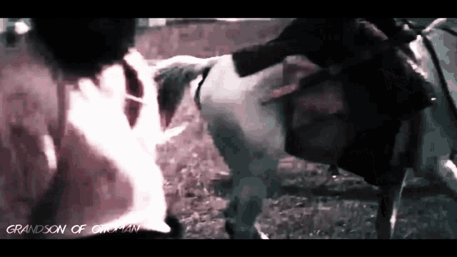 a black and white photo of a man riding a horse with the words grandson of a man on the bottom right