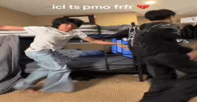 two boys are dancing in a bedroom with the words " ici ts pmo frfr " written on the ceiling