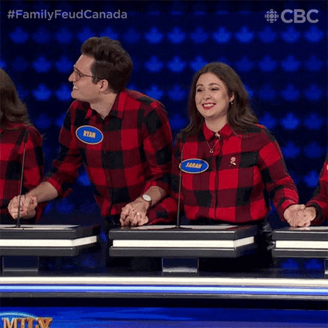 a man and a woman are playing a game on a television show called family feud canada