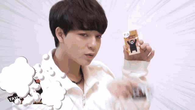 a person holding a card with a bear on it and the word yeah on the bottom