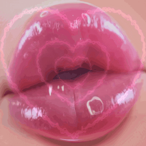a close up of a woman 's lips with a heart shaped bubble around them