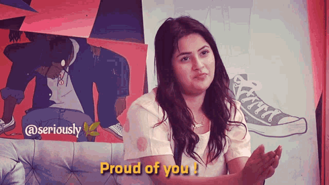 a woman says proud of you in front of a painting of a man