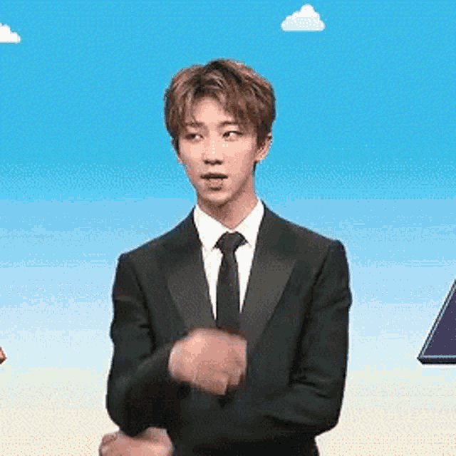 a young man in a suit and tie is dancing .