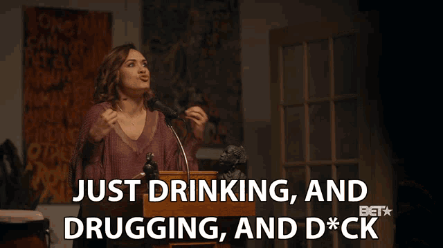 a woman stands at a podium and says just drinking and drugging and d*ck