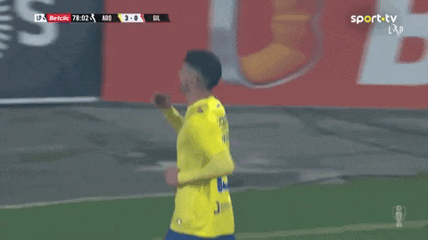 a soccer player wearing a yellow jersey with the number 19 on the back
