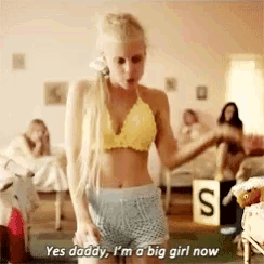 a woman in a yellow bra and blue shorts says yes daddy , i 'm a big girl now .
