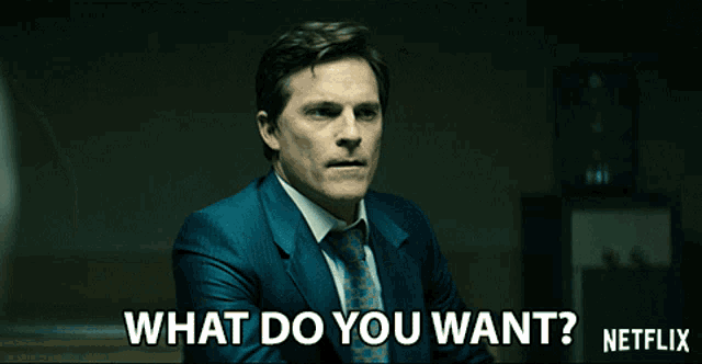 a man in a suit and tie asks what do you want