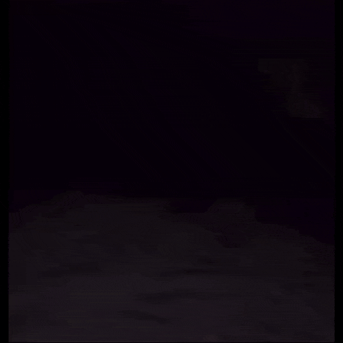 a person is laying on a bed with a ghost behind them .