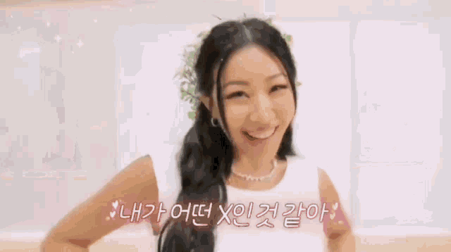 a woman wearing a flower crown is making a funny face .