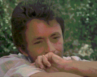 a man with a ring on his finger looks at the camera
