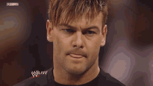 a close up of a man 's face with a w live logo on the bottom