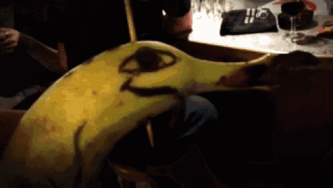 a banana with a face drawn on it sitting on a table
